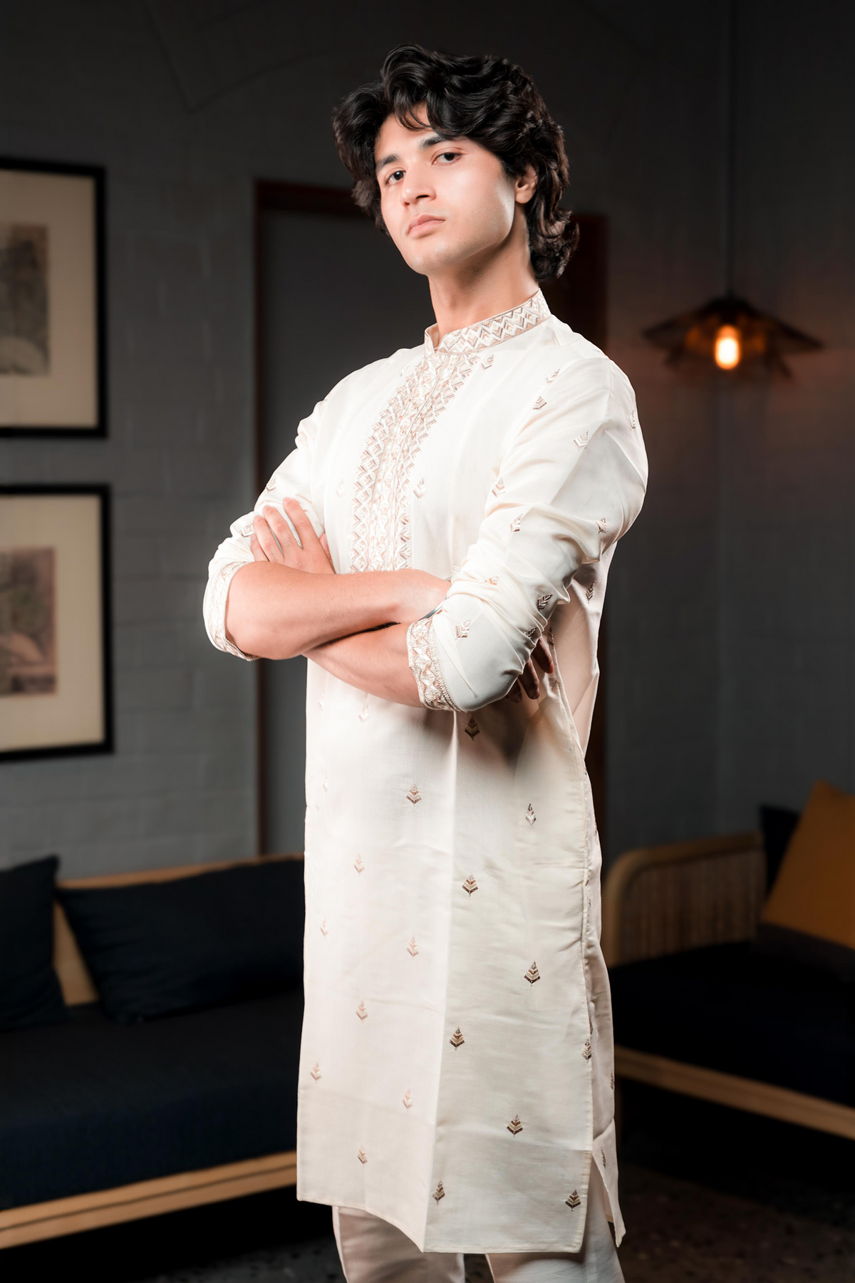 Cream silk kurta with embroidered golden motifs.