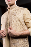 Gold long kurta jacket pant set.