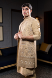 Gold long kurta jacket pant set.