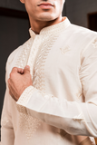 Cream silk kurta with embroidery.