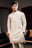 Cream silk kurta with embroidery.